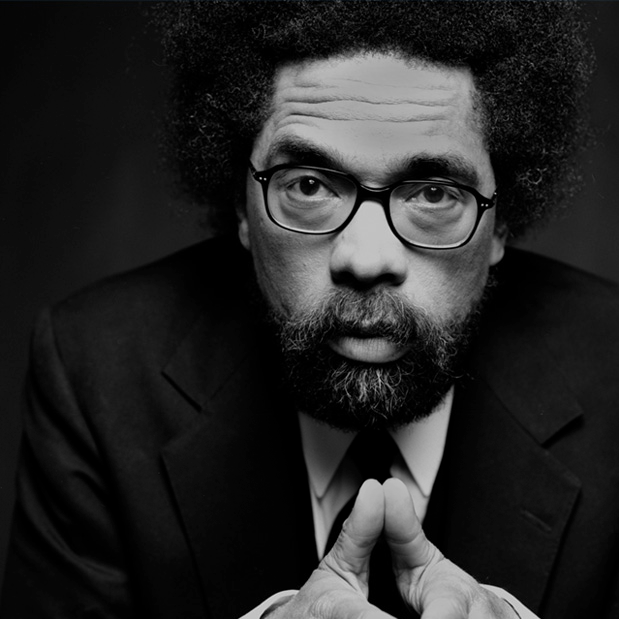 zoomed in black and white image of Cornel West looking into camera. He is wearing a suit and glasses